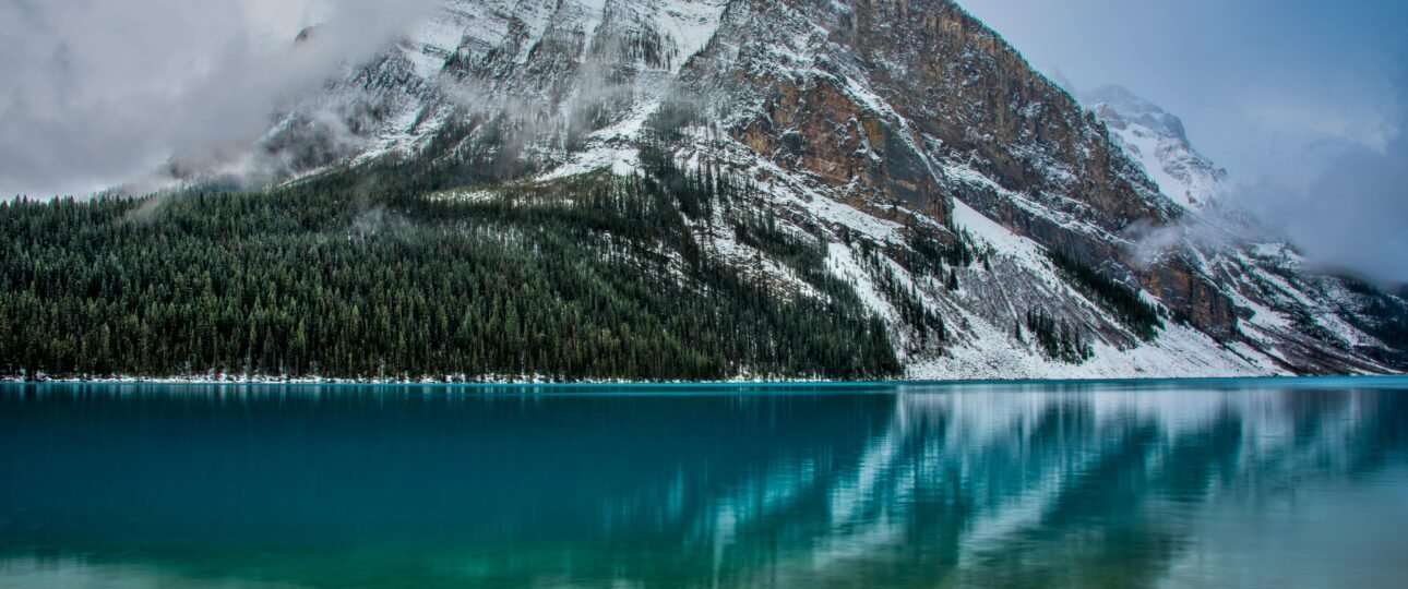 Aerial view of Moraine Lake surrounded by snow-capped Rocky Mountain peaks in Banff National Park, Alberta, Canada