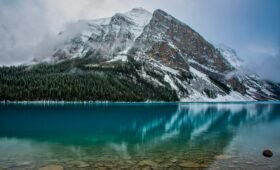 Aerial view of Moraine Lake surrounded by snow-capped Rocky Mountain peaks in Banff National Park, Alberta, Canada