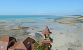 Calgary downtown skyline with the Calgary Tower visible and the Canadian Rocky Mountains in the background on a clear sunny day, Alberta, Canada