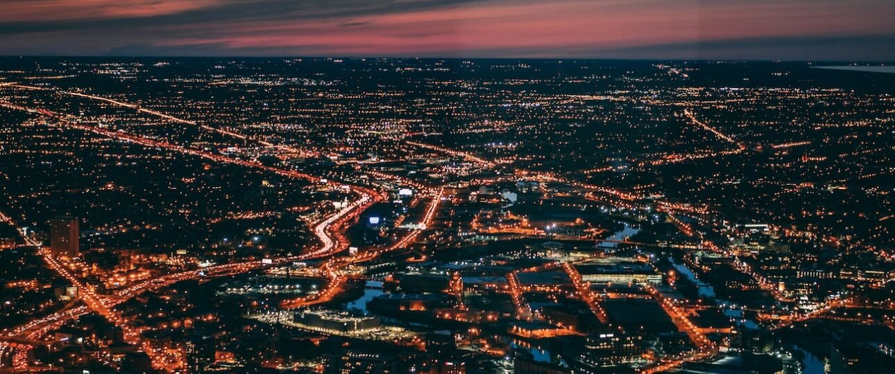 Edmonton city skyline rising above the North Saskatchewan River valley in Alberta, Canada, with green parkland in the foreground