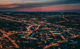 Edmonton city skyline rising above the North Saskatchewan River valley in Alberta, Canada, with green parkland in the foreground