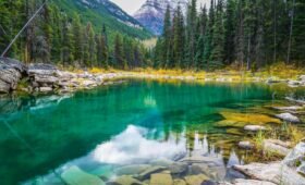 Banff town shuttle bus with the Rocky Mountains in the background, Alberta Canada