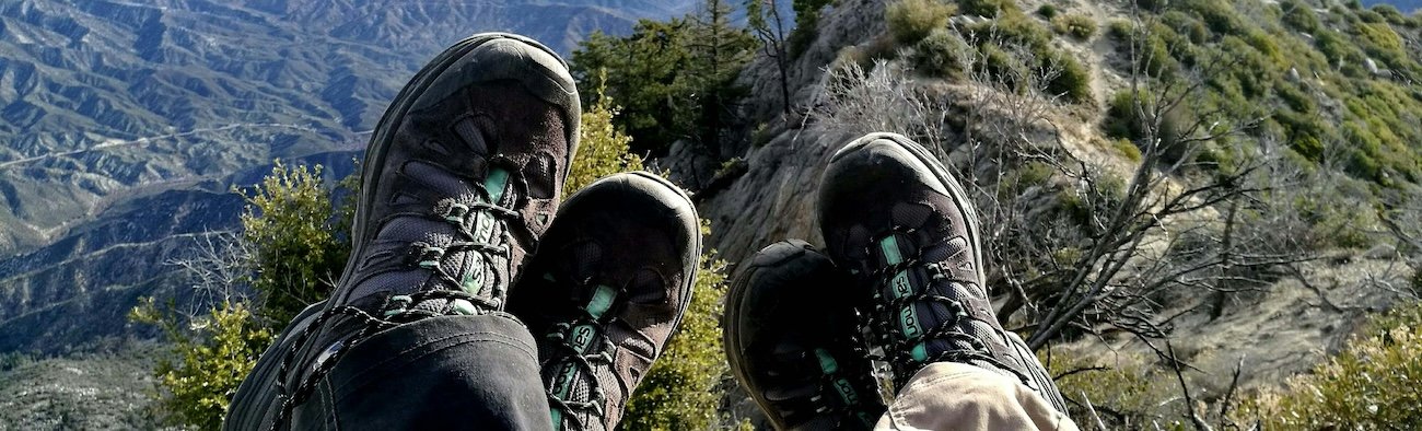 Hiker wearing waterproof jacket and base layers on a mountain trail in the Canadian Rockies