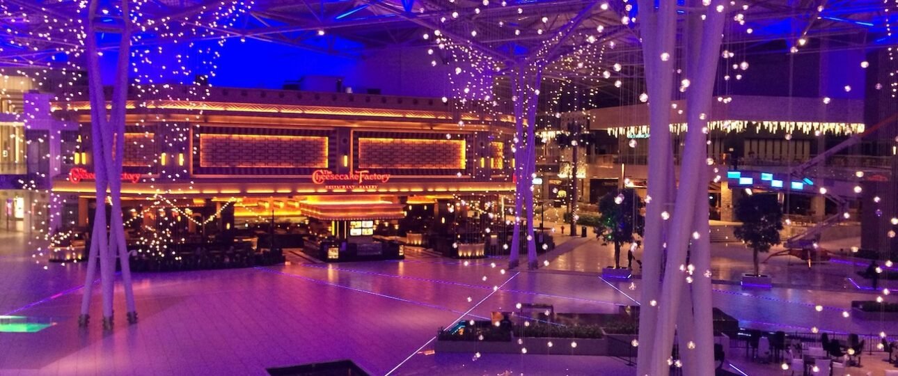 Families riding colourful attractions at Galaxyland indoor amusement park inside West Edmonton Mall, Alberta, Canada