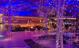 Families riding colourful attractions at Galaxyland indoor amusement park inside West Edmonton Mall, Alberta, Canada