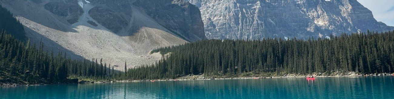 Moraine Lake surrounded by the Valley of the Ten Peaks in Banff National Park on a clear summer morning