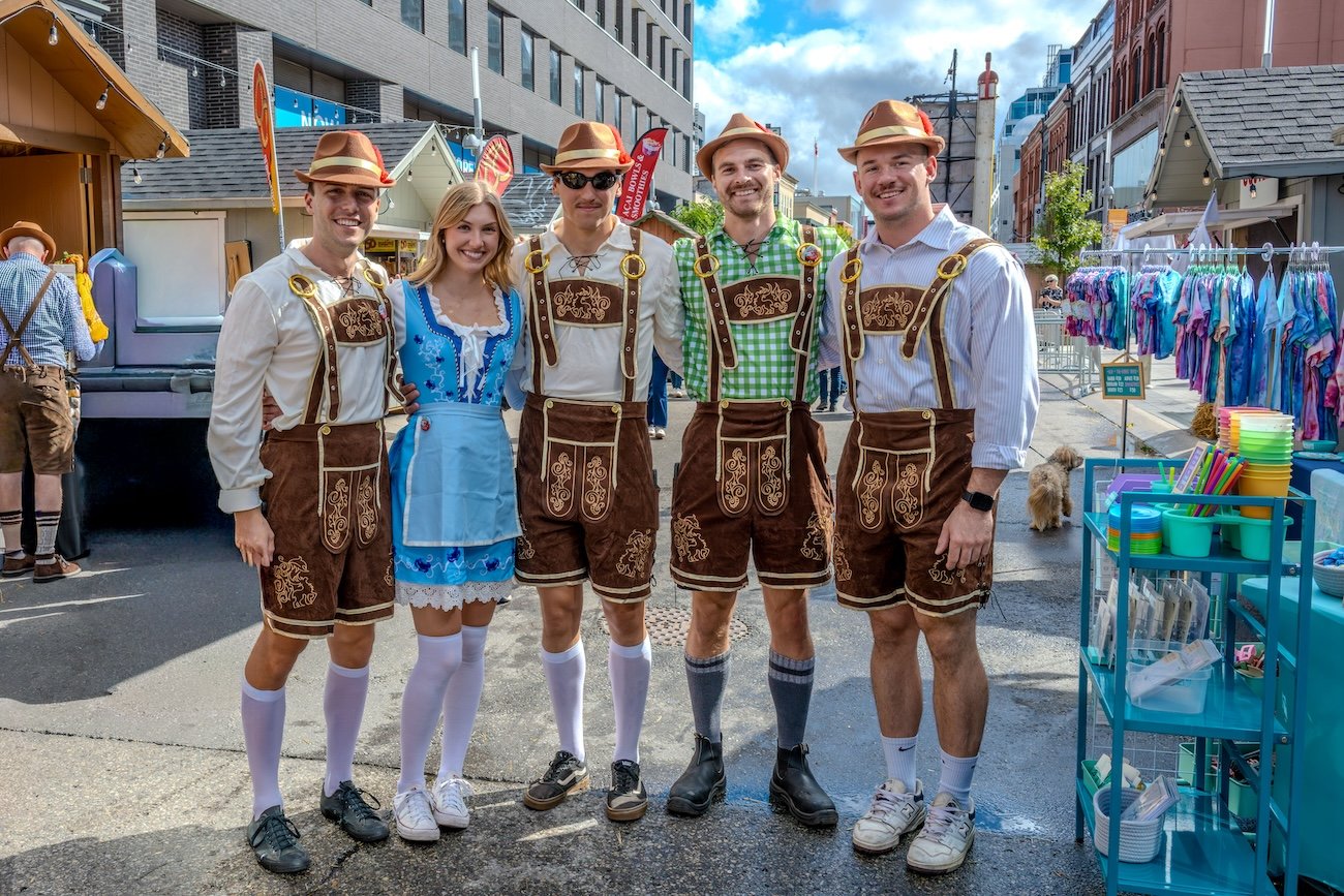 People wearing dirndl and lederhosen at Oktoberfest in Edmonton