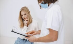 Doctor consulting with family in Alberta medical clinic - Health Quality Alberta patient experience