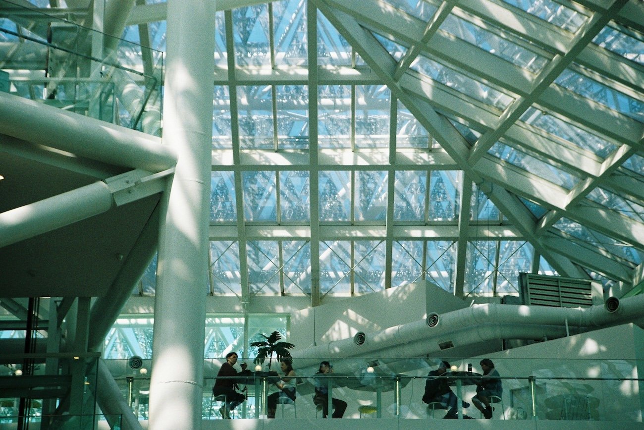 Romantic date ideas Edmonton – couple walking through Muttart Conservatory at night
