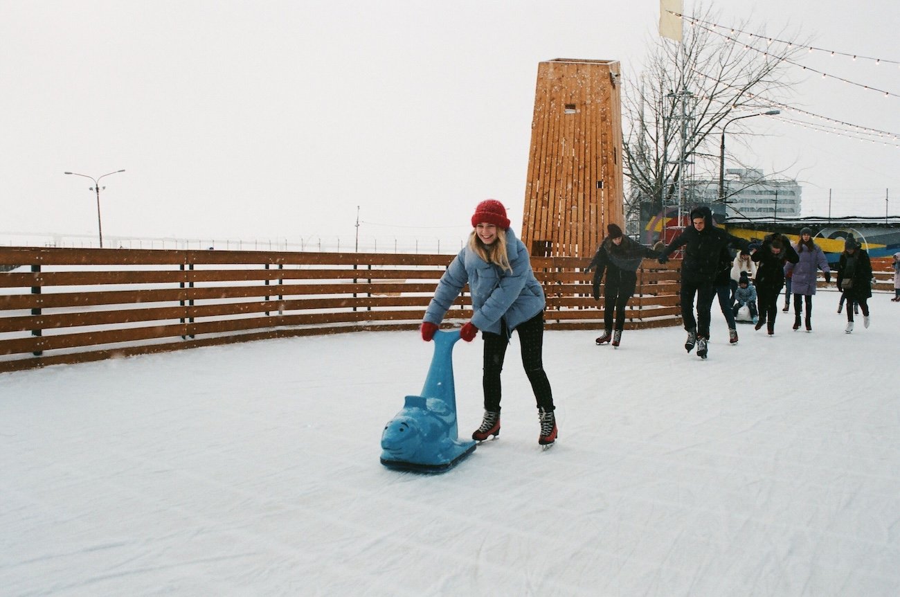 Winter date ideas Edmonton – couple ice skating on Victoria Park IceWay