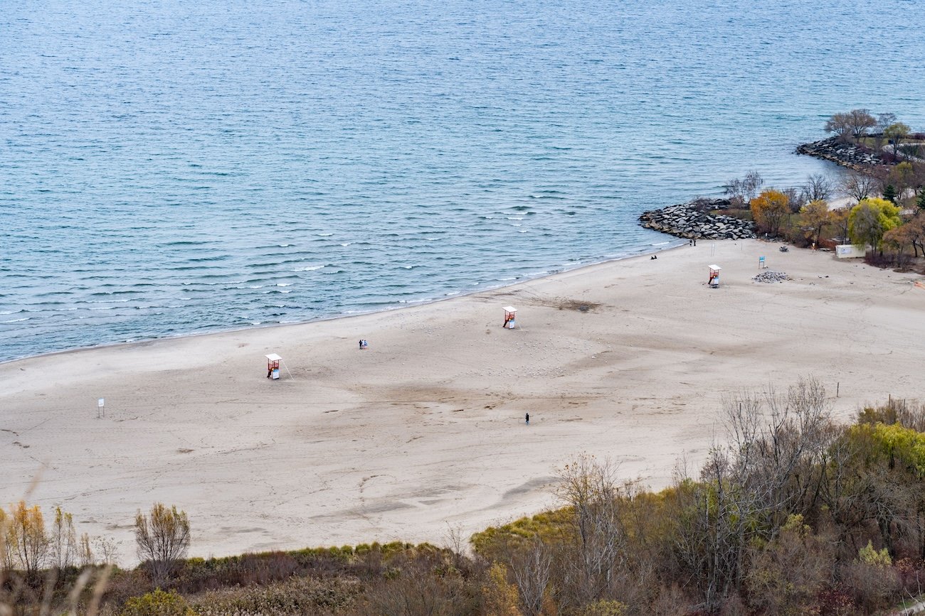 People swimming at Anniversary Park beach on Chestermere Lake, one of the popular shallow swimming areas